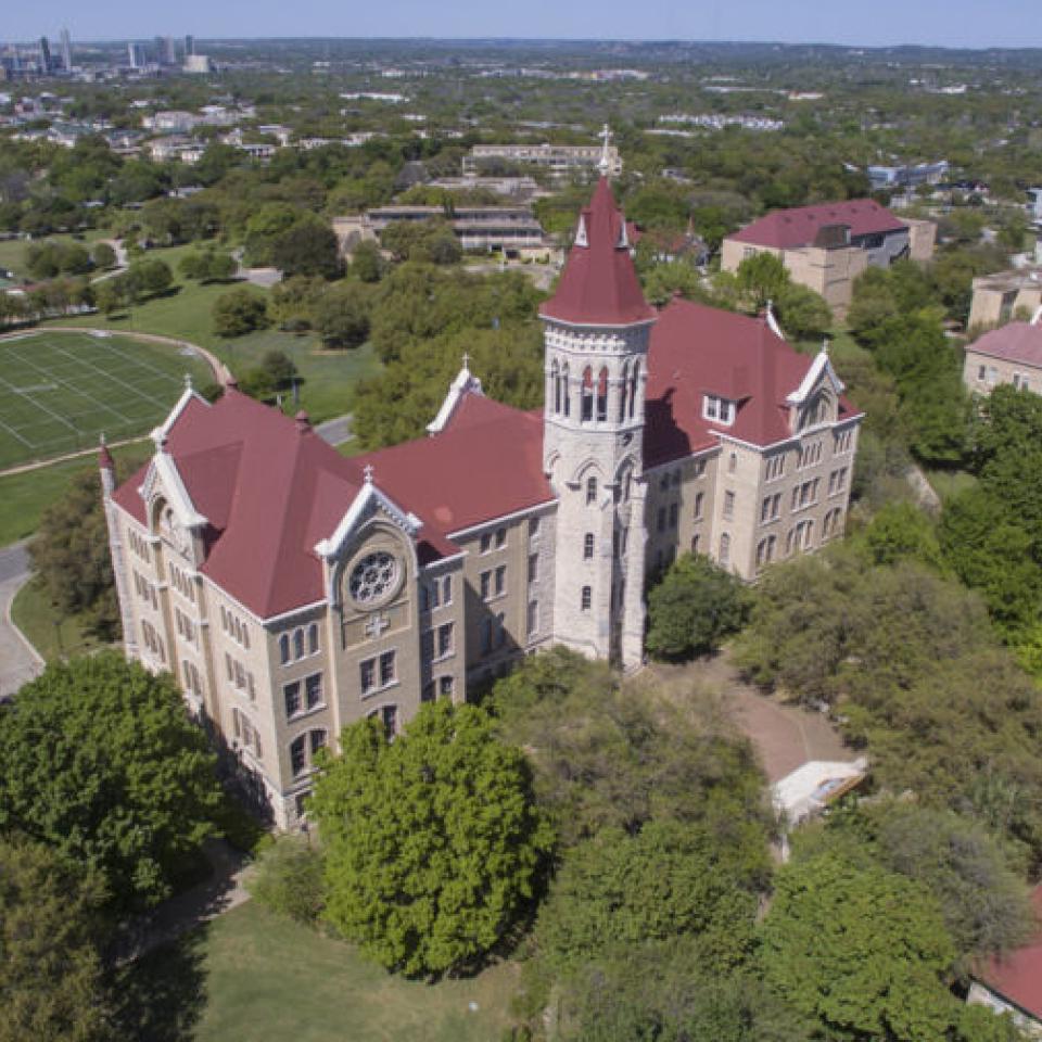 Aerial view of the St. Edward's University campus with the downtown skyline in the distance