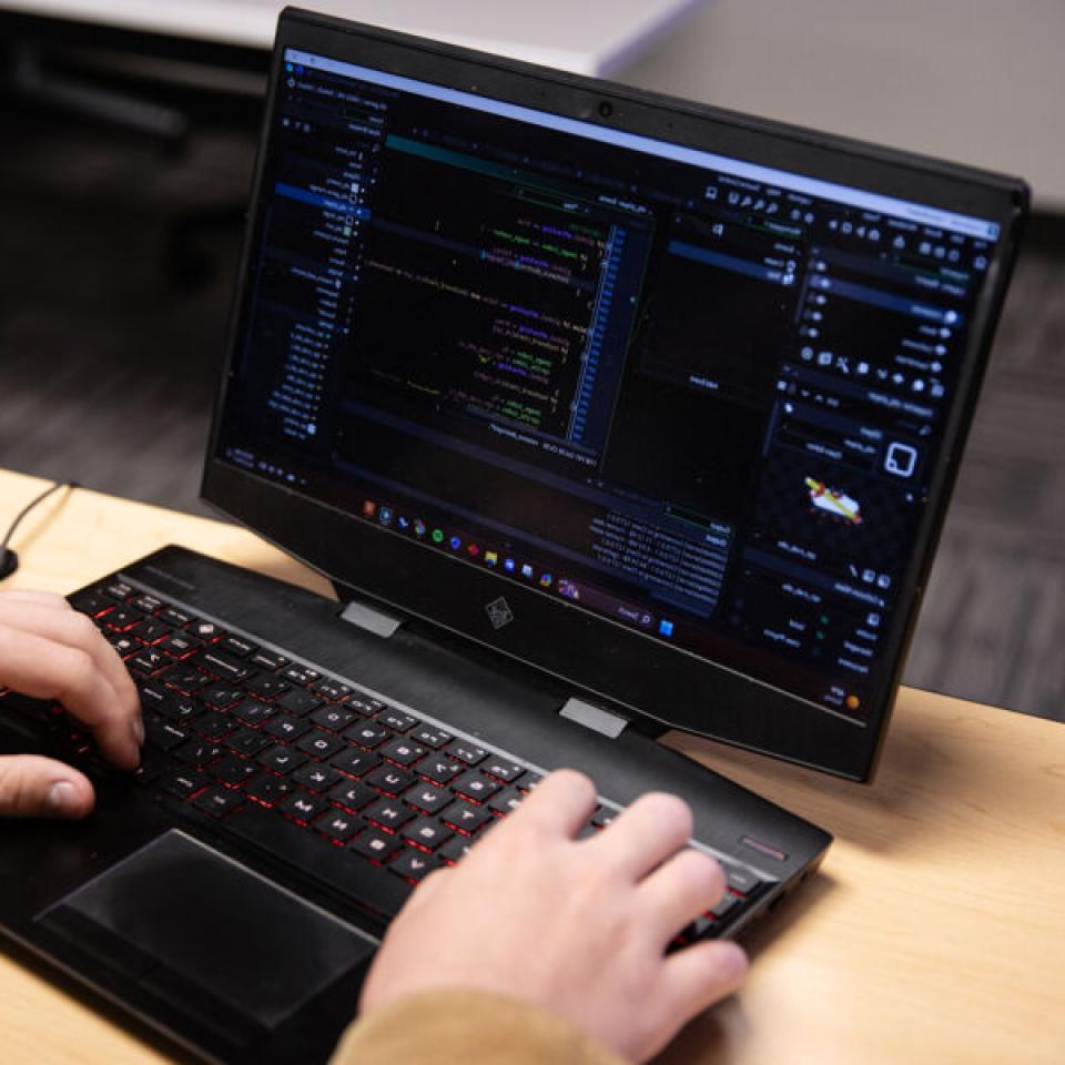 Laptop display showcasing coding examples for software development.