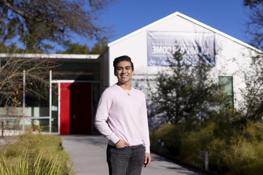 Cristobal Diaz stands in the Campus Ministry Courtyard with the Campus Ministry Building in the background.