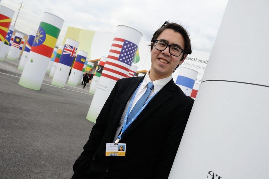 Chris Jackson standing in front of flag banners